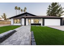 Stunning curb appeal featuring a remodeled home with a paved walkway and lush landscaping at 1743 W Butler Dr, Phoenix, AZ 85021