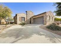 Beautiful single-story home featuring stone accents, a large driveway, and a well-maintained front yard at 20750 N 87Th St # 1009, Scottsdale, AZ 85255