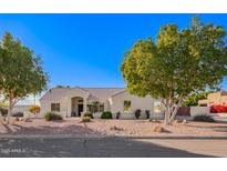 Single-story home with landscaped yard and two-car garage at 23204 N Paseo Laredo Ln, Peoria, AZ 85383