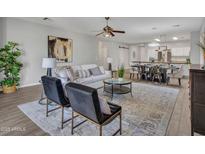 Open living area features a neutral color palette, plush seating, and a large window at 29699 N 126Th Dr, Peoria, AZ 85383