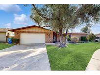 Ranch style home with mature landscaping and a two-car garage at 7134 N 14Th St, Phoenix, AZ 85020