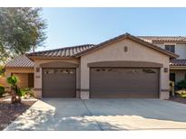 House exterior featuring a two-car garage and desert landscaping at 12821 W Whitton Ave, Avondale, AZ 85392