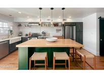 Modern kitchen with butcher block island, stainless steel appliances, and white shaker cabinets at 1425 E Desert Cove Ave # 24, Phoenix, AZ 85020