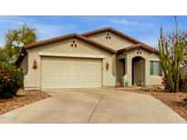 Charming single-story home featuring a two-car garage, desert landscaping, and a neutral stucco exterior at 42374 W Avella Dr, Maricopa, AZ 85138