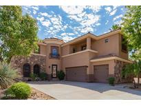 Two-story house with stone accents and a three-car garage at 5023 E Lucia Dr, Cave Creek, AZ 85331