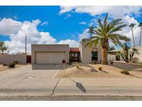 Single-story home with desert landscaping and two-car garage at 7785 E Luke Ln, Scottsdale, AZ 85250