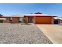 Brick ranch house with orange garage door and gravel driveway at 10329 W Griswold Rd, Peoria, AZ 85345