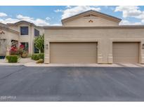 Two-car garage with desert landscaping and stucco exterior at 11022 N Indigo Dr # 127, Fountain Hills, AZ 85268