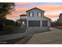 Two-story home with a three-car garage and landscaped yard at 12053 N 157Th Ave, Surprise, AZ 85379