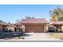 Tan stucco house with brown garage door and desert landscaping at 12234 S Shoshoni Dr, Phoenix, AZ 85044