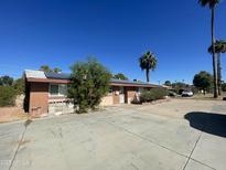 Ranch-style home with solar panels and a large driveway at 1324 W Bethany Home Rd, Phoenix, AZ 85013