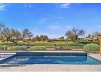 Luxury pool with golf course view; outdoor kitchen and seating area at 17444 N 79Th St, Scottsdale, AZ 85255