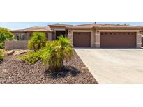 Two-story house with a three-car garage and landscaped front yard at 17925 W Mauna Loa Ln, Surprise, AZ 85388