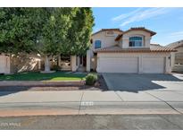 Two-story house with a large front yard, two-car garage, and mature tree at 1931 W Mulberry Dr, Chandler, AZ 85286