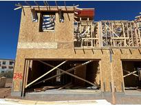 Exterior of new home under construction featuring wood framing and an open garage space on a sunny day at 21048 N 58Th St, Phoenix, AZ 85054