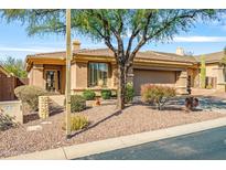 Single-story home with desert landscaping, two-car garage, and neutral exterior at 41604 N Cedar Chase Rd, Anthem, AZ 85086