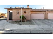 Charming single-story home featuring desert landscaping, tile roof, private drive, and an attached two-car garage at 4511 W Valencia Dr, Laveen, AZ 85339