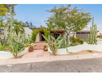 Stunning curb appeal with desert landscaping and a charming entrance at 4622 E Palo Verde Dr, Phoenix, AZ 85018