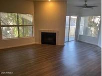 Bright living room with fireplace and sliding glass door to patio at 600 W Grove Pkwy # 2067, Tempe, AZ 85283