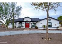 White single-story home with red door, gray roof, and landscaped yard at 6118 N 183Rd Ave, Waddell, AZ 85355