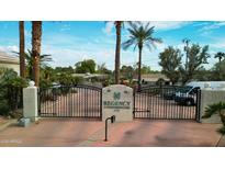 Regency Condominiums gated entrance with palm trees and well-maintained landscaping at 7777 E 2Nd St # 101, Scottsdale, AZ 85251