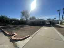 Front view of a single story home with driveway at 801 W Earll Dr, Phoenix, AZ 85013