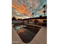 Inviting pool and patio area with stunning sunset views at 941 W Peralta Ave, Mesa, AZ 85210