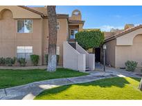 Attractive exterior of a two-story condo building with landscaping and walkways at 10101 N Arabian Trl # 2052, Scottsdale, AZ 85258