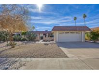 Single story home with desert landscaping and a two car garage at 10625 W Deanne Dr, Sun City, AZ 85351