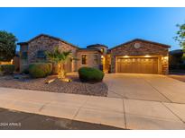 Stunning desert home with appealing stone elevation, landscaping, and a three-car garage at 12519 W Bajada Rd, Peoria, AZ 85383