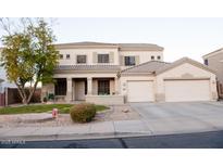 Two-story house with attached garage and landscaped front yard at 1414 N Estrada --, Mesa, AZ 85207