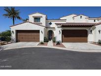 Charming home featuring a three-car garage, desert landscaping, and a light stucco exterior with a red tile roof at 14200 W Village Pkwy # 113, Litchfield Park, AZ 85340