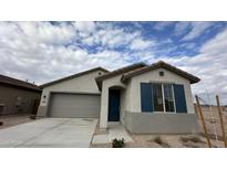 New single-story home with gray exterior, two-car garage, and blue shutters at 15790 W Hackamore Dr, Surprise, AZ 85387