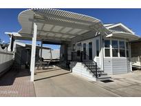 Home exterior featuring a covered patio and landscaping at 17200 W Bell Rd # 196, Surprise, AZ 85374