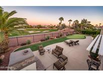 Outdoor oasis with putting green, seating area, and golf course views at 21935 N San Ramon Dr, Sun City West, AZ 85375