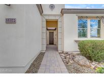 Inviting entryway with a stone path leading to front door at 35372 N Sunset Trl, Queen Creek, AZ 85140