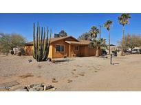 Tan house with a two-car garage and desert landscaping at 538 S Meridian Rd, Apache Junction, AZ 85120