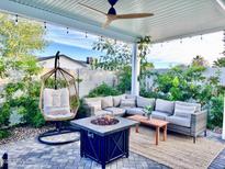 Relaxing backyard patio with fire pit, seating area, and covered pergola at 8114 E Clarendon Ave, Scottsdale, AZ 85251