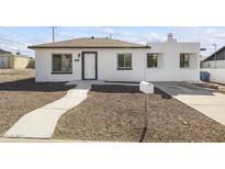 Remodeled single story home with a white exterior and landscaped walkway at 1423 E Cholla St, Phoenix, AZ 85020
