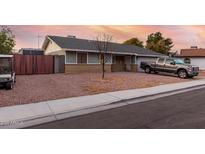 Ranch style home with a two-car garage and landscaped yard at 1424 S Temple Cir, Mesa, AZ 85204