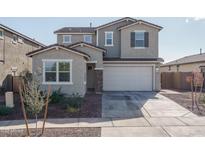 Two-story house with attached garage and landscaping at 17289 W Surrey Dr, Surprise, AZ 85388