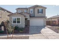 Two-story house with a two-car garage and landscaping at 17289 W Surrey Dr, Surprise, AZ 85388