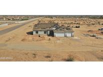 New construction home showing roof tiles being installed, and a two car garage at 22270 W Skinner Rd, Wittmann, AZ 85361