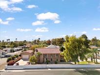 Aerial view of a large two-story home with a red tile roof and a spacious yard at 6550 N 7Th St, Phoenix, AZ 85014