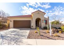 Single-story home with brown garage door and desert landscaping at 7517 W Noble Prairie Way, Florence, AZ 85132