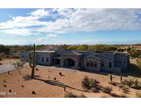 Stunning desert contemporary home with a large covered patio and stone accents at 8110 E Saddle Horn Rd, Scottsdale, AZ 85255