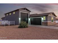 Two-story house with a large garage and landscaped yard at 10447 W Appaloosa Trl, Casa Grande, AZ 85194