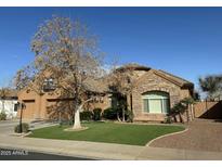 Beautiful Craftsman style home with a 3-car garage and manicured lawn at 20334 E Colt Dr, Queen Creek, AZ 85142