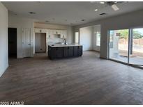 Open kitchen with island, stainless steel appliances, and white cabinets at 22216 W Skinner Rd, Wittmann, AZ 85361