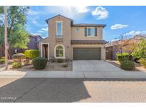 Two-story house with a green garage door and landscaped front yard at 3617 E Half Hitch Pl, Phoenix, AZ 85050